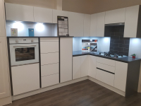 Integra gloss handleless kitchen with white glass appliances